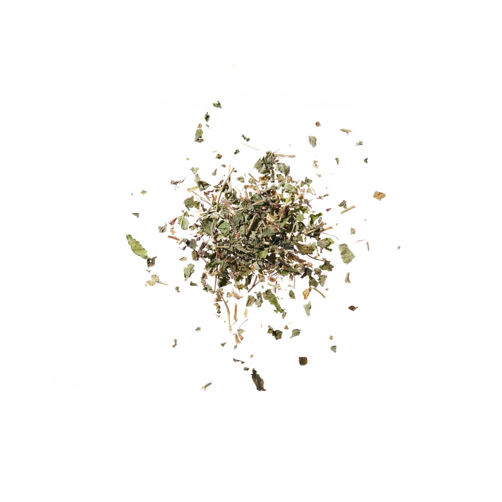 A pile of dried herbs and leaves scattered on a white background.